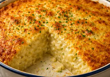 Golden baked cheese and potato pie with creamy potato filling and melted Cheddar in an ovenproof dish