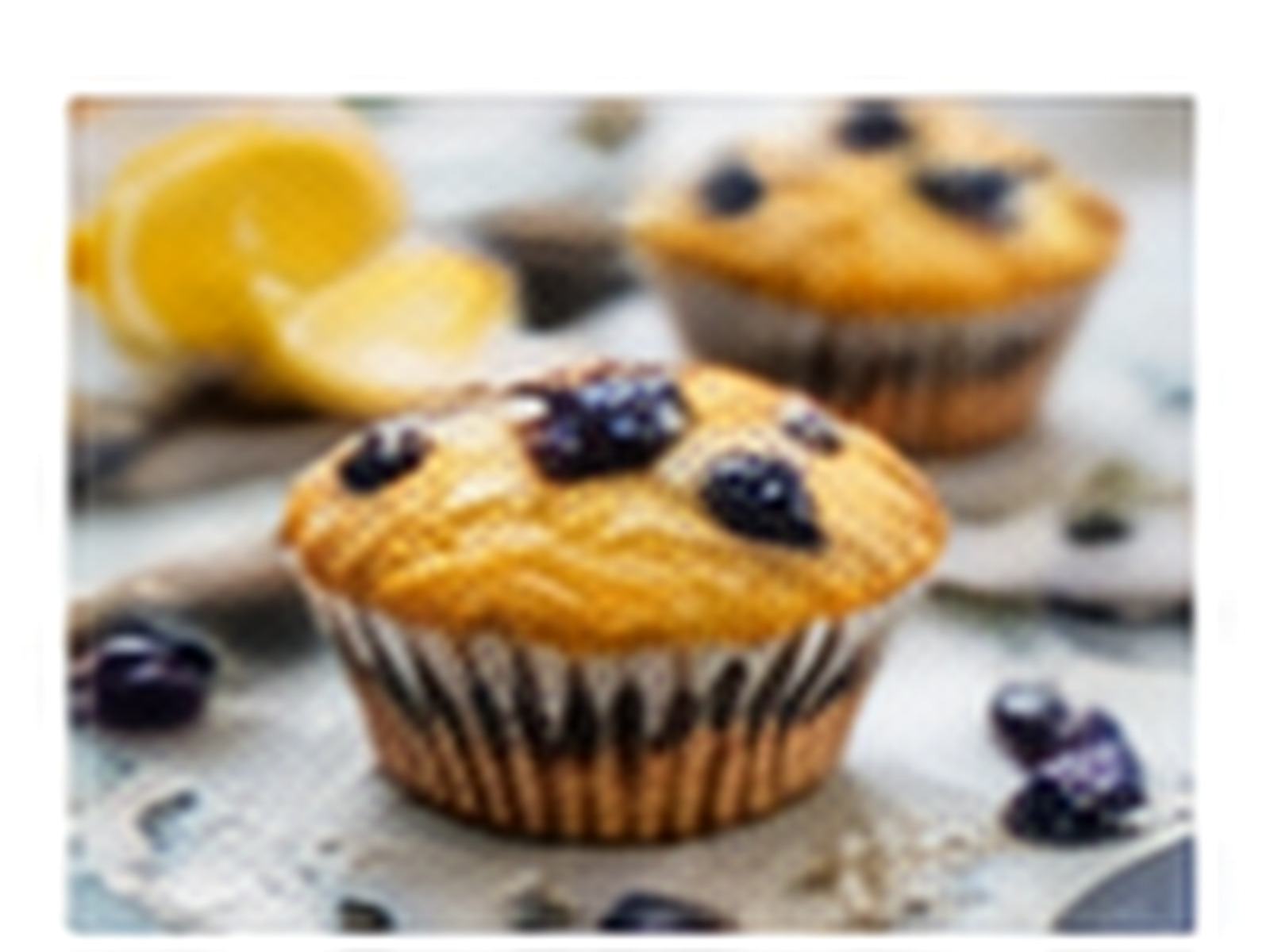 Lemon and blueberry breakfast muffins topped with fresh blueberries